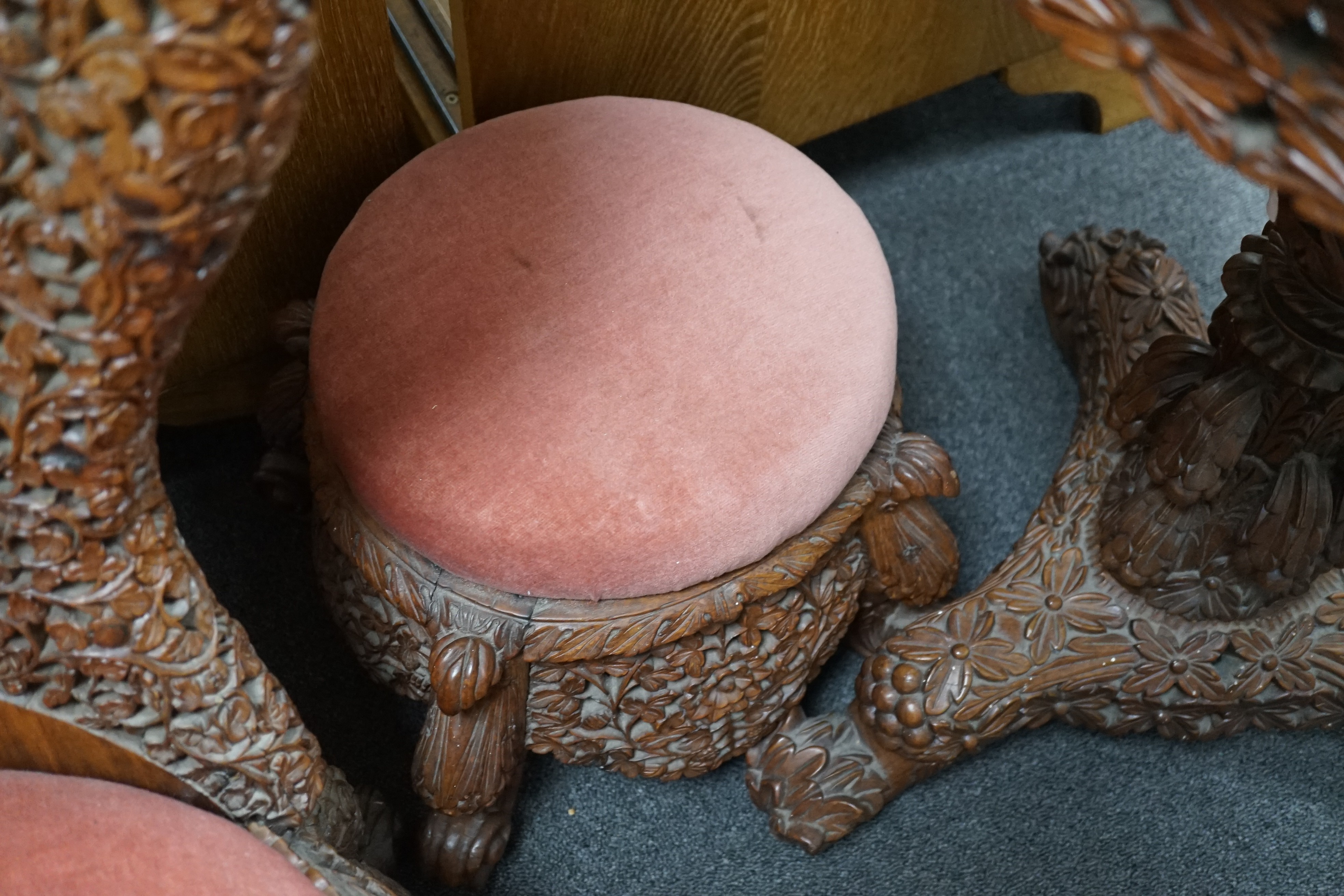 A Burmese carved hardwood circular occasional or centre table, diameter 57cm height 74cm, together with a similar side chair and foot stool
